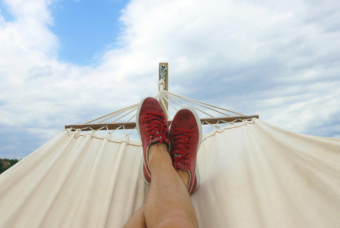 Point of view of legs resting in a hammock